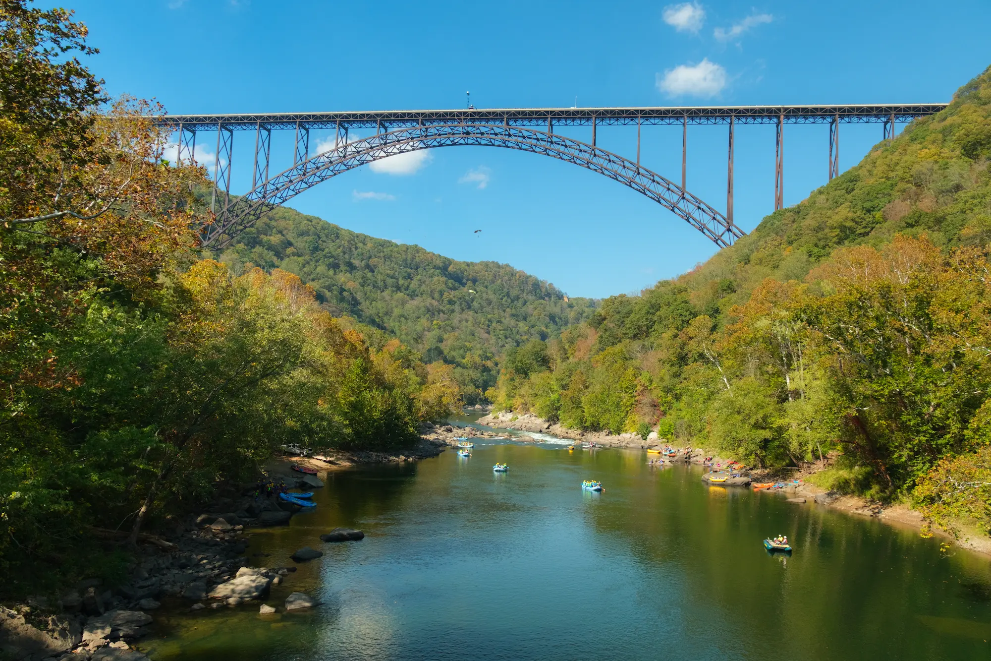 Rafters floating under the New River Gorge Bridge during Bridge Day.
